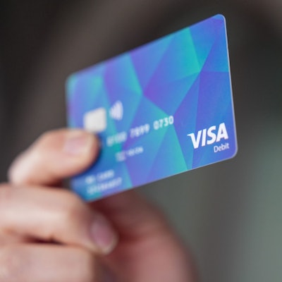 Ein Mann hält in Hamburg eine Bezahlkarte in der Hand.