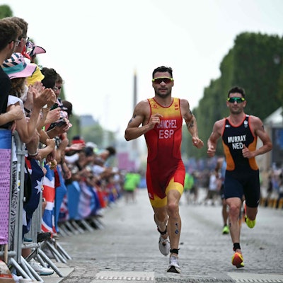 Spain's Roberto Sanchez Mantecon and Netherlands' Richard Murray compete in the running stage during the men's individual triathlon at the Paris 2024 Olympic Games in central Paris on July 31, 2024. (Photo by Ben STANSALL / AFP)