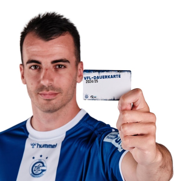 VfL-Spieler Milos Vujovic hält eine Dauerkarte des VfL Gummersbach in die Höhe.