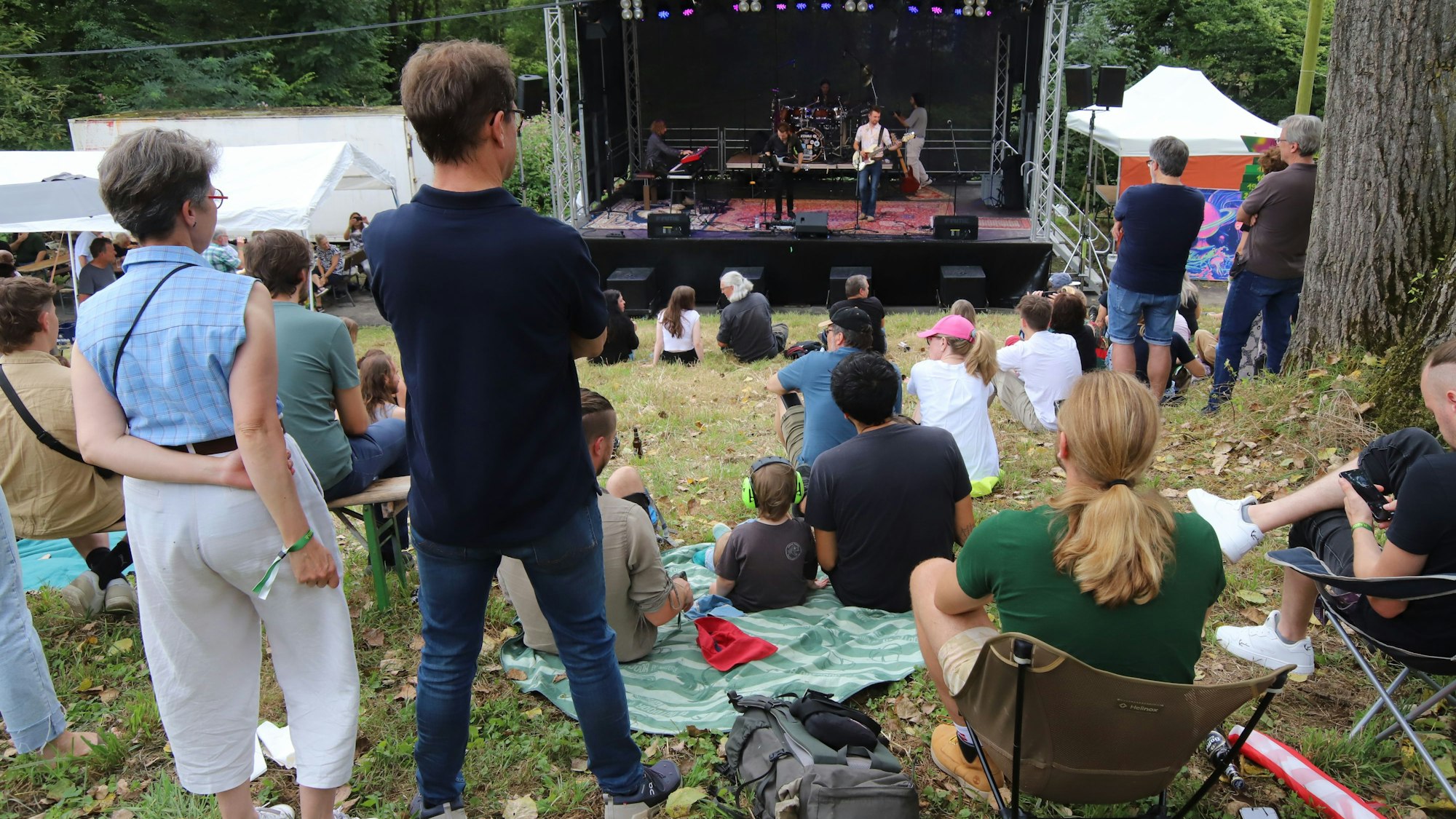 Eine Bühne und Besucher auf der Wiese