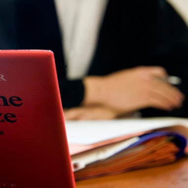 Ein Anwalt sitzt hinter der aufgeschlagenen «Schönfelder Textsammlung Deutsche Gesetze».