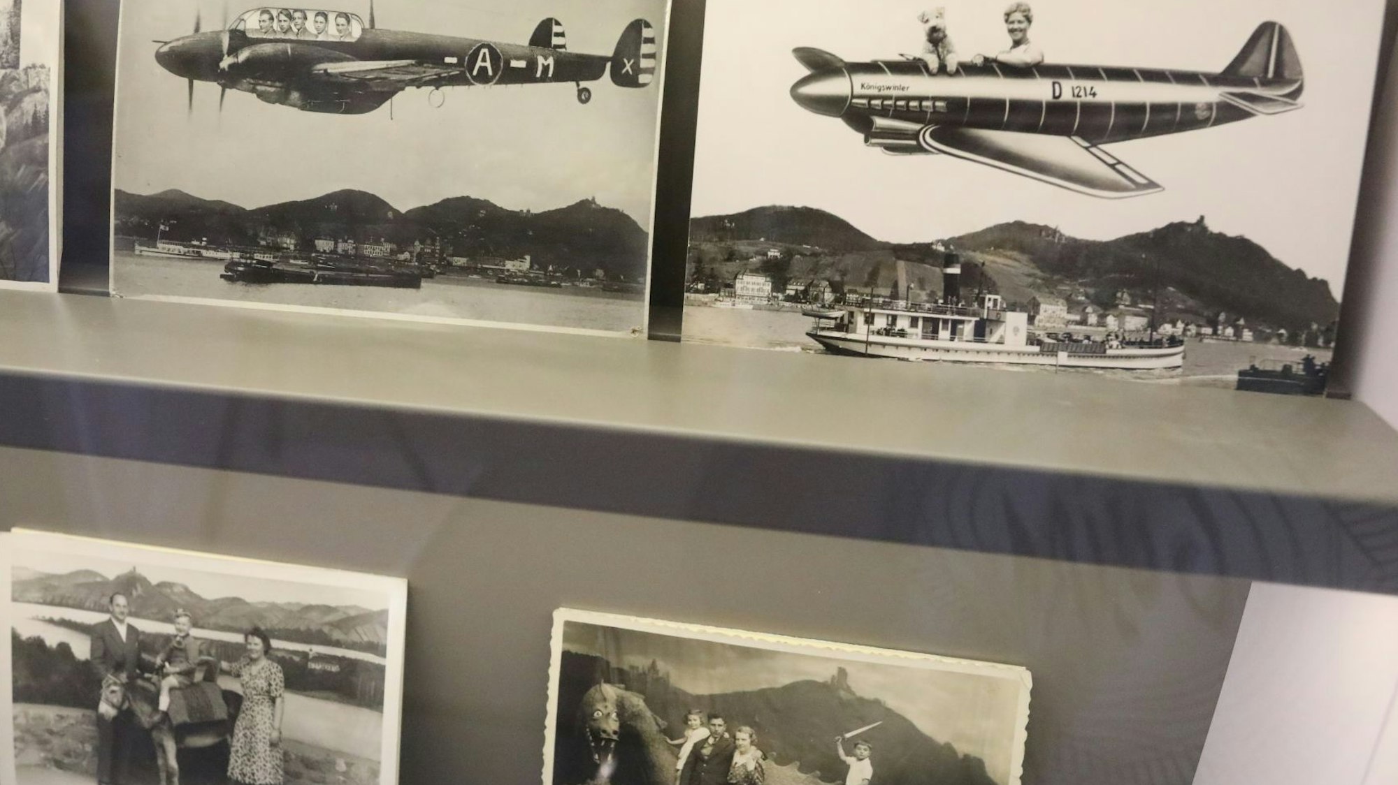 Alte Schwarz-Weiß-Aufnahmen mit Menschen in Flugzeugattrappen vor der Kulisse des Siebengebirges.