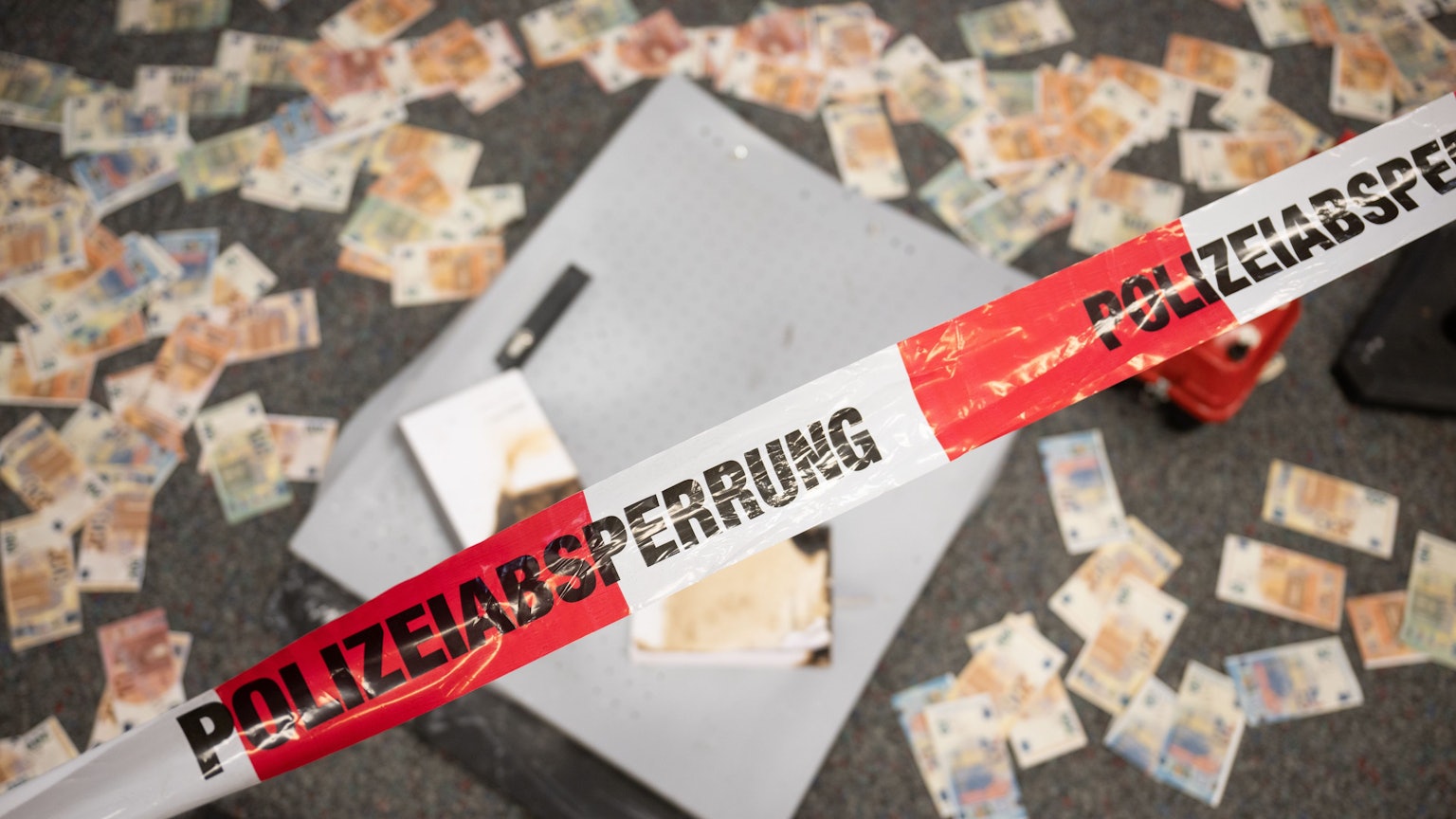 ARCHIV - 10.05.2023, Hessen, Wiesbaden: Musterbanknoten liegen während einer Pressekonferenz zum Kampf gegen Geldautomatensprengungen im Landeskriminalamt Hessen vor einem Geldautomat, der zu Testzwecken durch das LKA gesprengt wurde (Symbolbild).