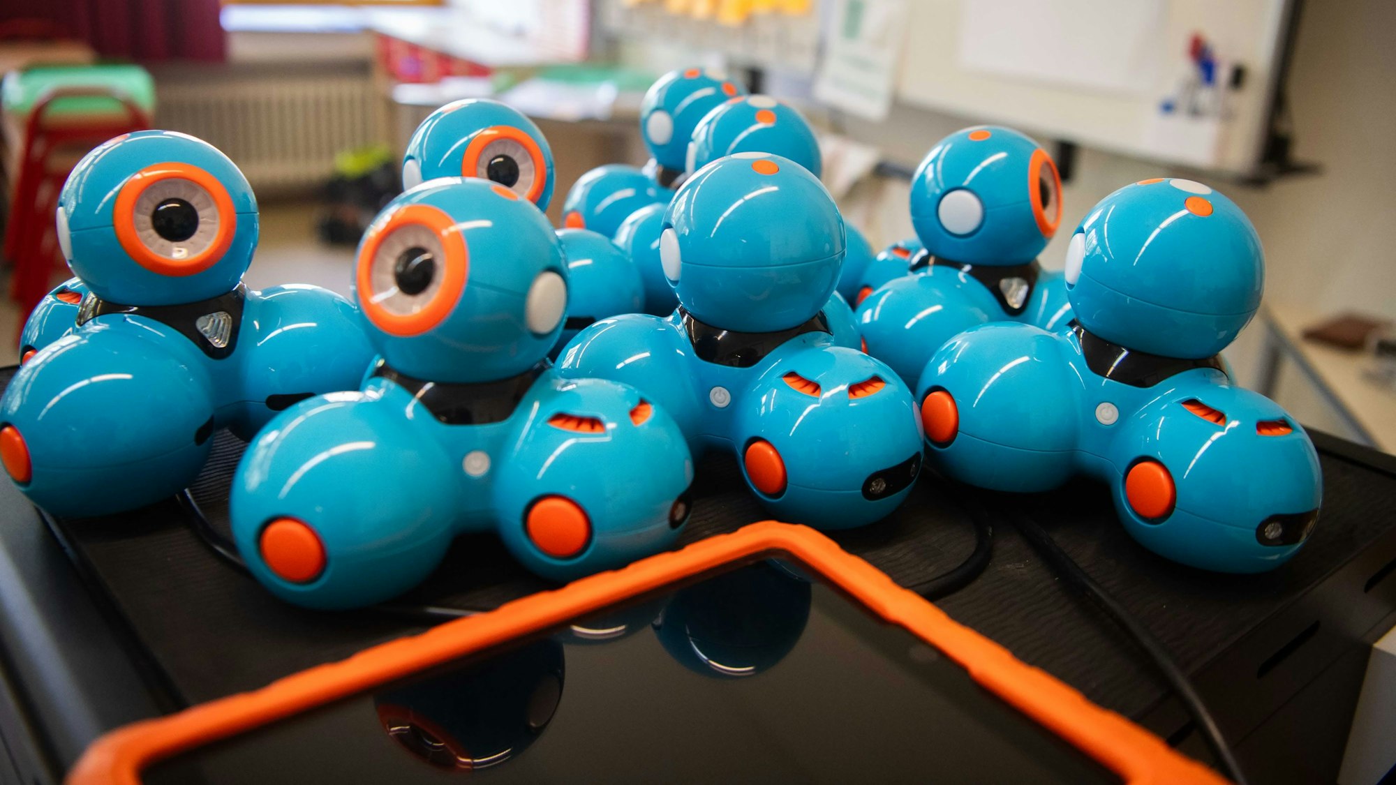 Steuerbare Roboter mit drei Rädern liegen auf einer spiegelnden Oberfläche.