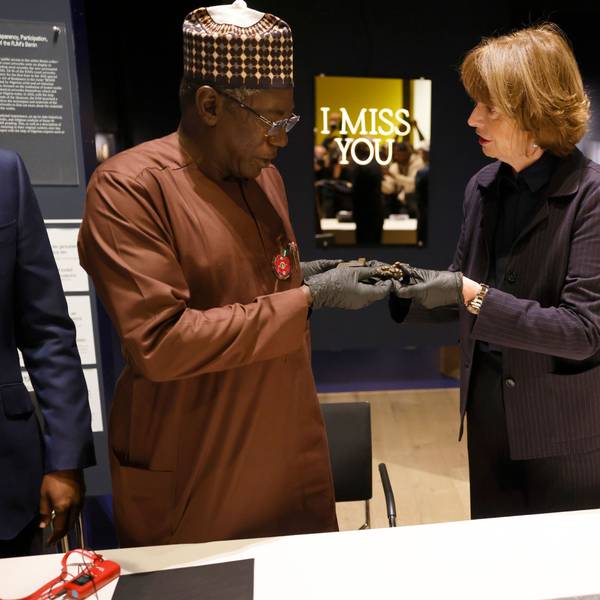 Henriette Reker (r, parteilos), Oberbürgermeisterin von Köln, übergibt Abba Isa Tijani, Generaldirektor der Nationalen Kommission für Museen und Monumente, symbolisch einen bronzenen Schlüssel aus dem Königreich Benin.