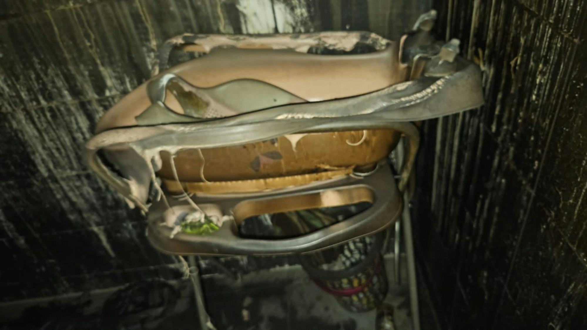 Eine Babyschale steht in einer ausgebrannten Wohnung.