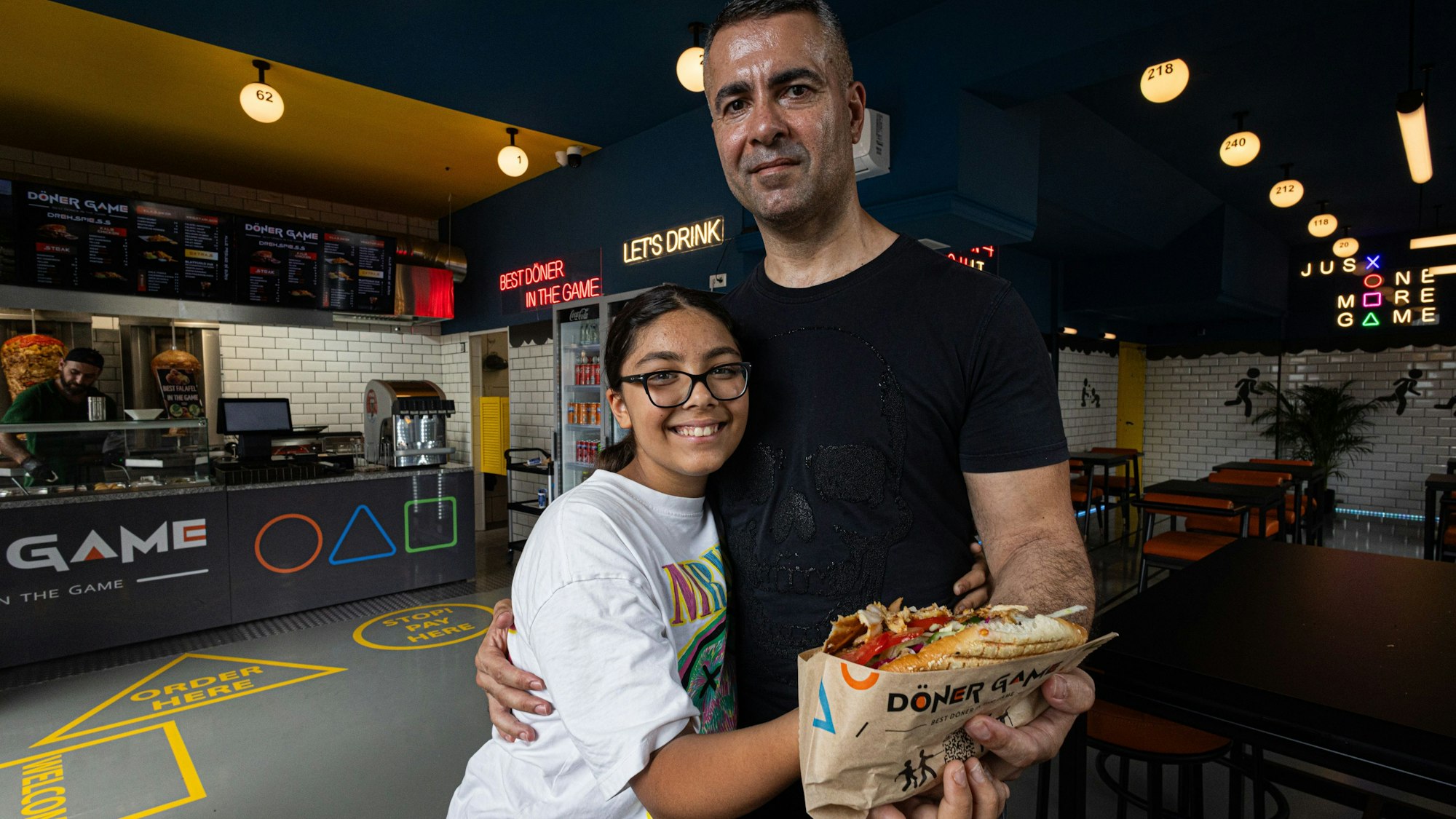 Ali Gül
und seine Tochter Dilay Gül halten einen Burger in die Kamera.
