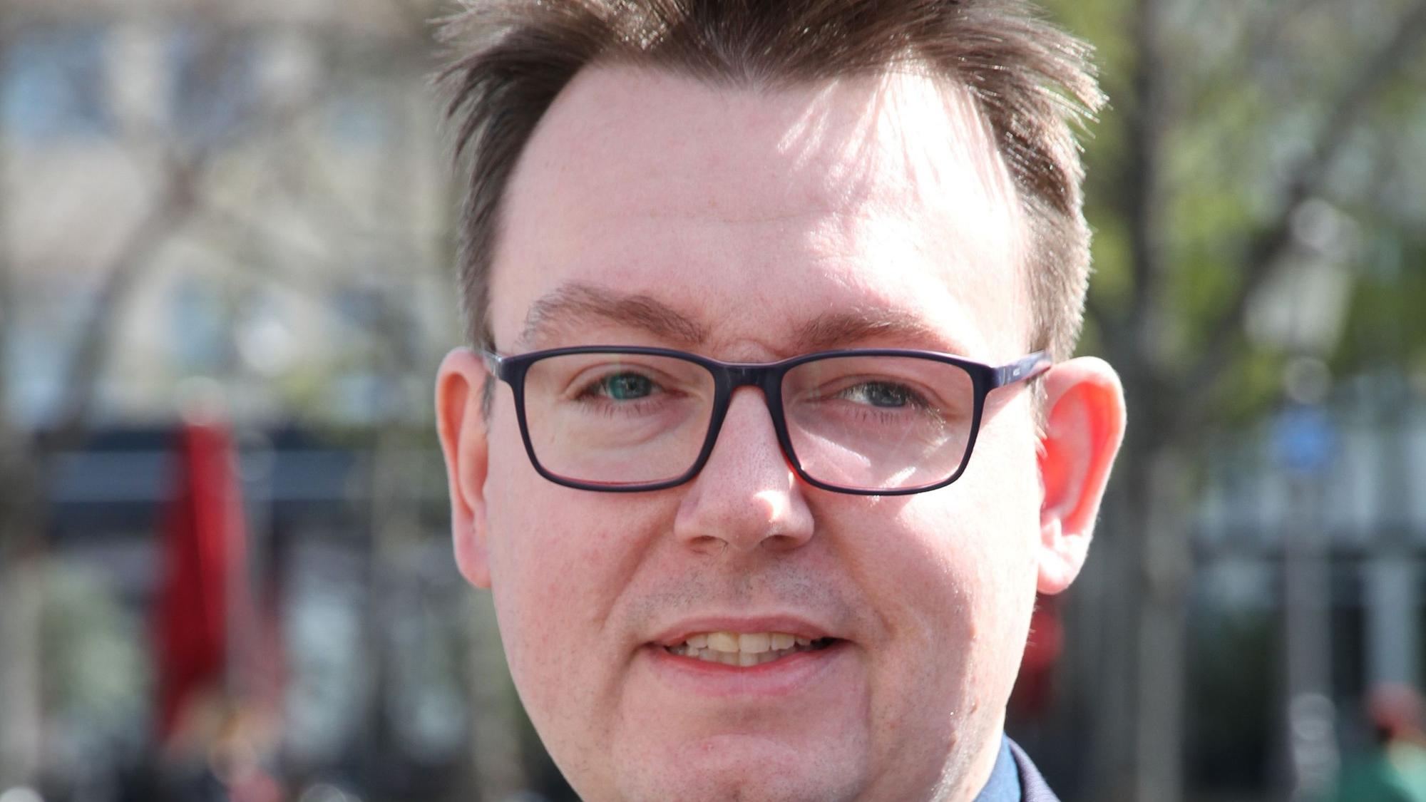 Das Bild zeigt den Kopf von Denis Waldästl, er trägt eine Brille.