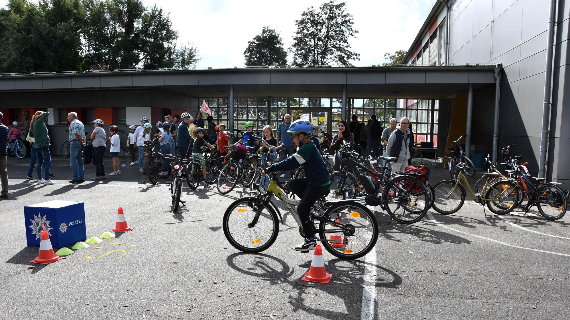 Ein Kind fährt auf einem Schulhof Fahrrad.