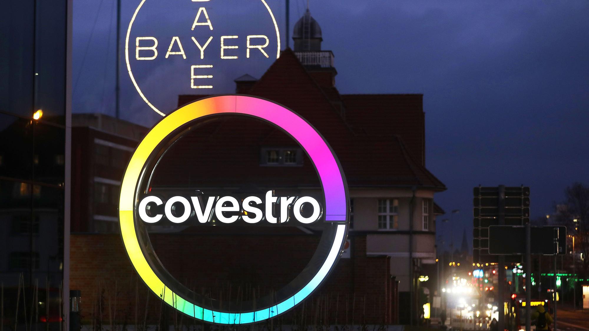 Das Logo des Kunststoffkonzern Covestro leuchtet am Morgen vor der Unternehmenszentrale am Chempark Leverkusen.