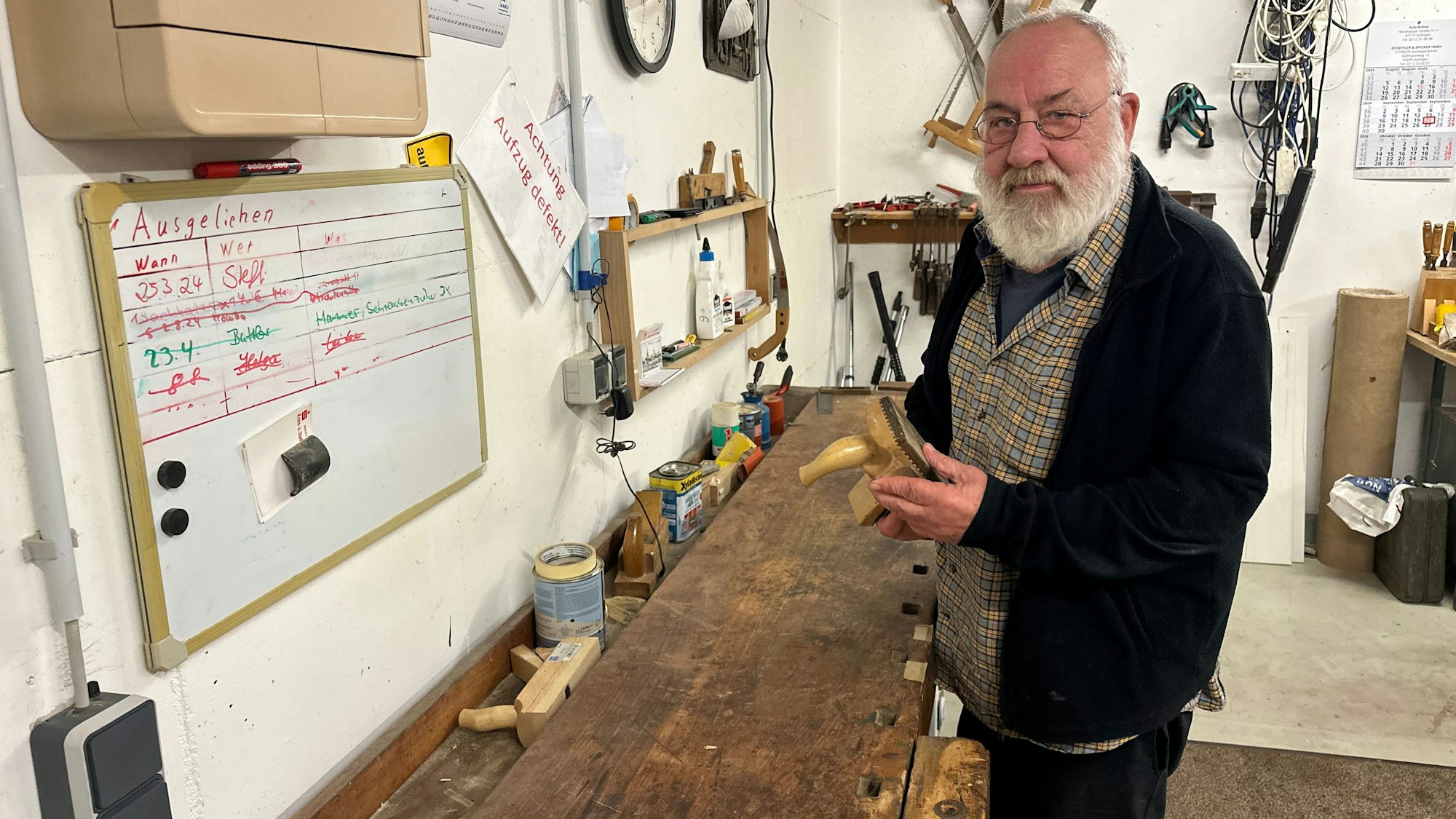 Peter Grunewald steht vor seiner Werkbank im gemeinsamen Werkraum der WG.