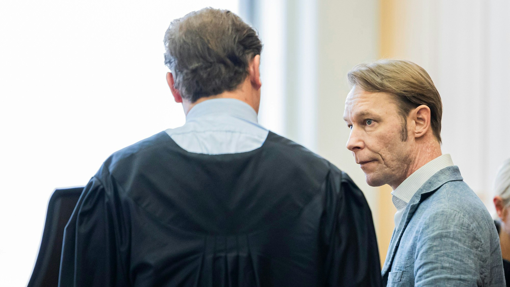Der Angeklagte Christian B. (r) steht vor Prozessbeginn im Gerichtssaal im Landgericht Braunschweig.