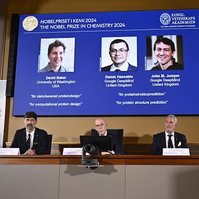 Johan Åqvist, member of the Nobel Committee for Chemistry, Hans Ellegren, Permanent Secretary and Heiner Linke, Chairman of the Nobel Committee for Chemistry award this years Nobel Prize in Chemistry to David Baker, Demis Hassabis, and John M Jumper at the Royal Swedish Academy of Sciences, in Stockholm, Sweden, Wednesday, Oct. 9, 2024. (Christine Olsson/TT News Agency via AP)