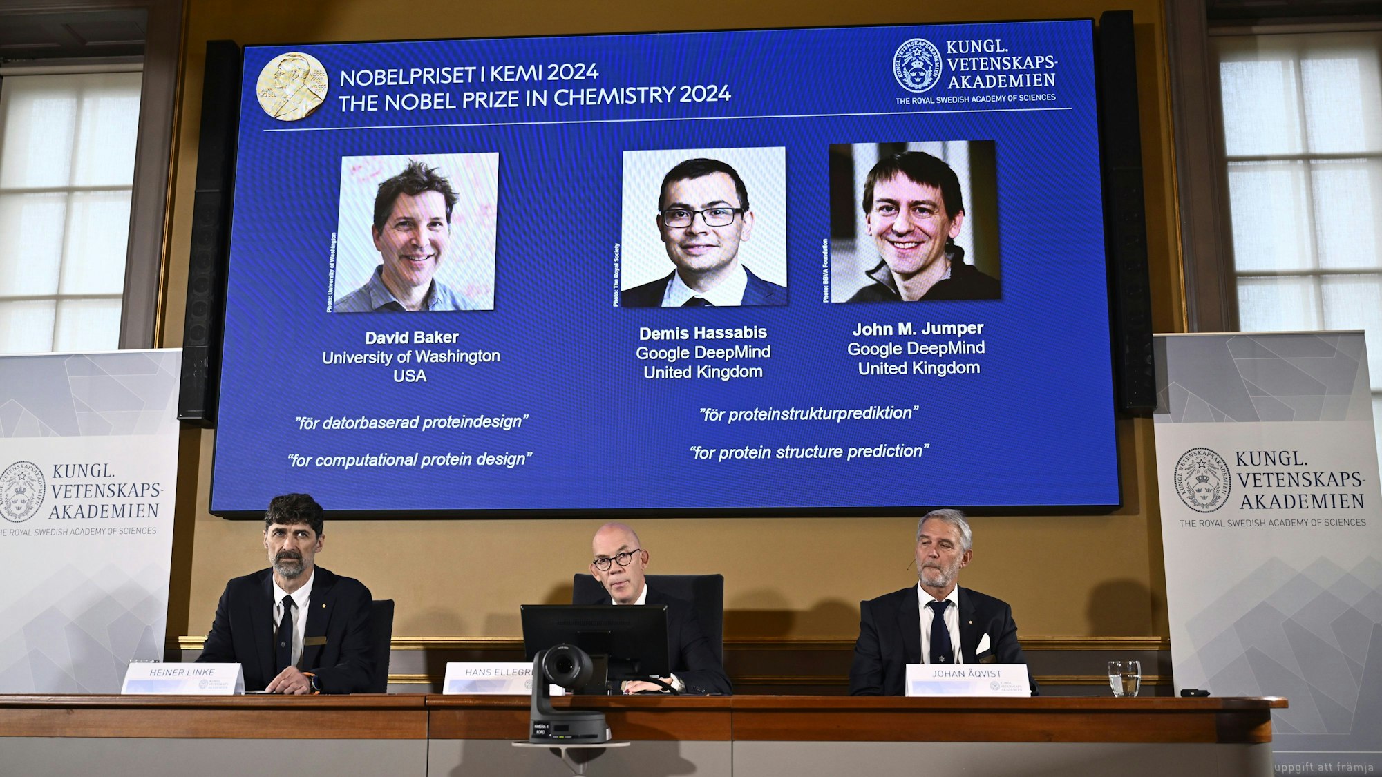 Johan Åqvist, member of the Nobel Committee for Chemistry, Hans Ellegren, Permanent Secretary and Heiner Linke, Chairman of the Nobel Committee for Chemistry award this years Nobel Prize in Chemistry to David Baker, Demis Hassabis, and John M Jumper at the Royal Swedish Academy of Sciences, in Stockholm, Sweden, Wednesday, Oct. 9, 2024. (Christine Olsson/TT News Agency via AP)