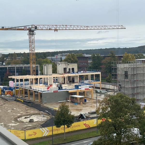 DHL baut ein neues Innovation-Center in Troisdorf, Richtfest war am 9. Oktober 2024. Blick auf den Rohbau mit einem Kran und Beton- sowie Holzfertigteilen.