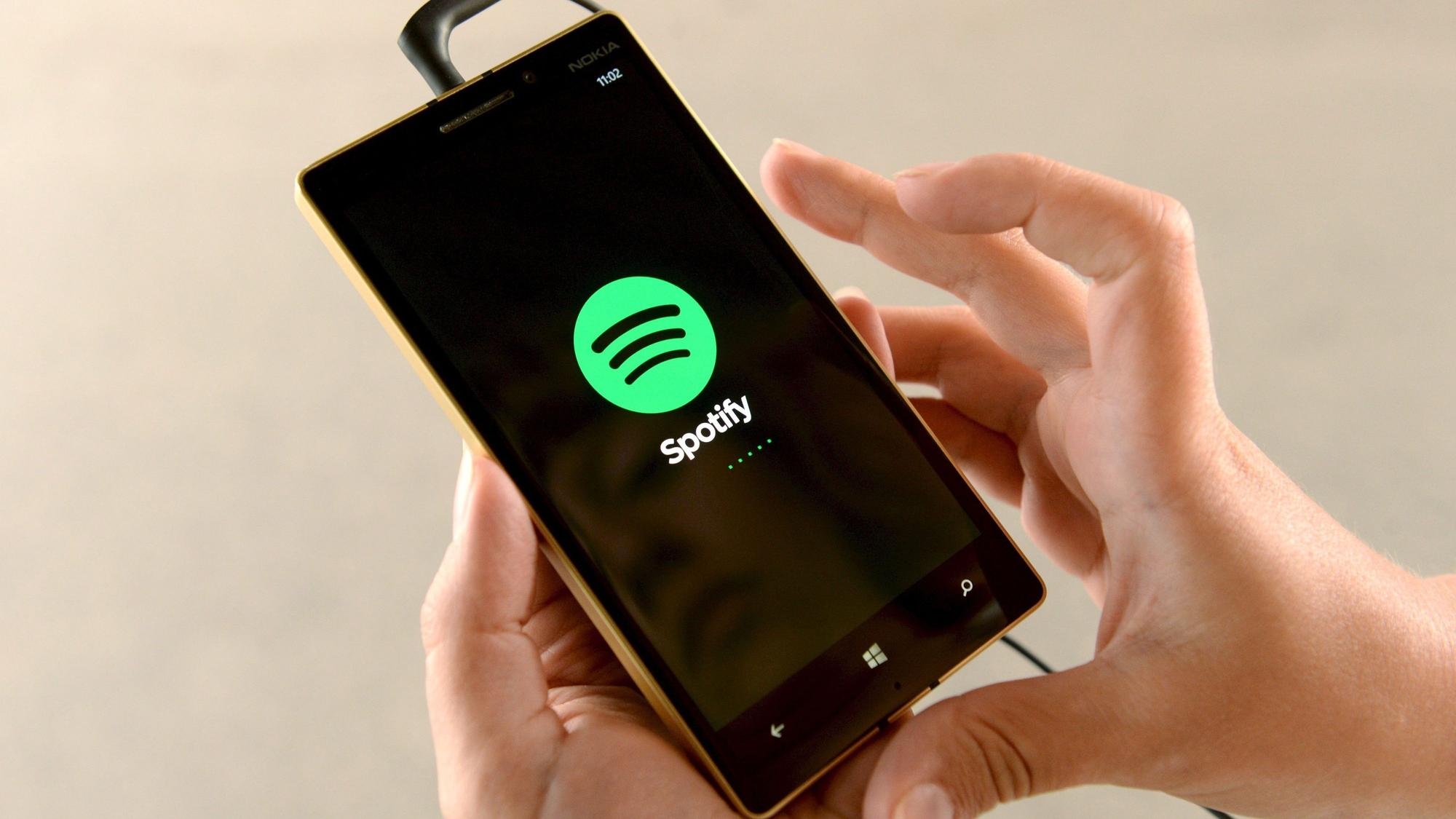 Das Logo des Streaming-Musikdienstes Spotify ist auf einem Smartphone zu sehen.