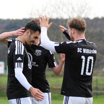 Das Bild zeigt drei Spieler des SC Wißkirchen, die ein Tor bejubeln.