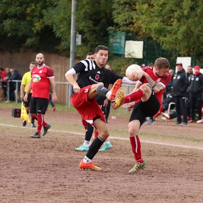 Zwei Fußballer kämpfen auf dem Aschenplatz im Eifelstadion in Mechernich um den Ball.