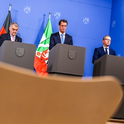 Josefine Paul, Herbert Reul, Hendrik Wüst und Benjamin Limbach stehen hinter Pulten.