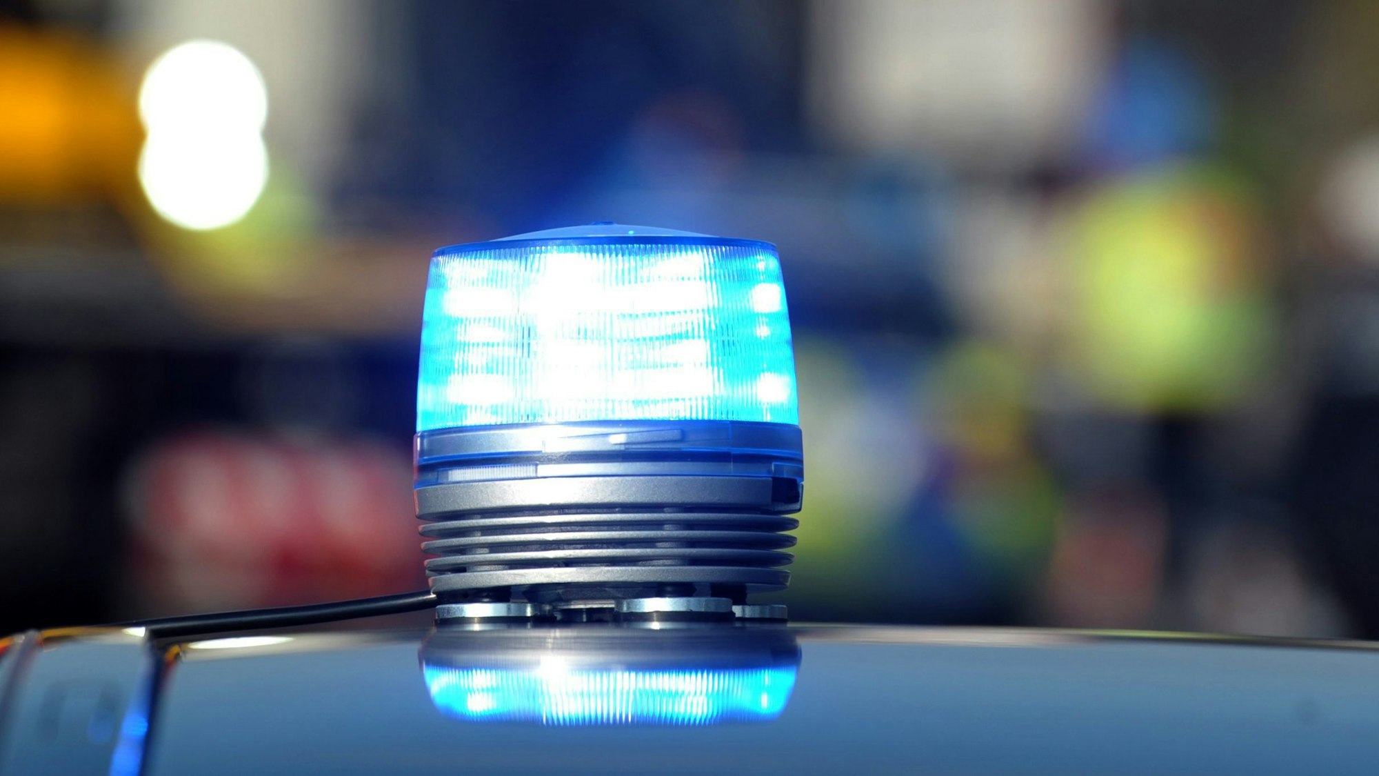 Eine Nahaufnahme eines leuchtenden Blaulichtes eines Streifenwagens der Polizei.