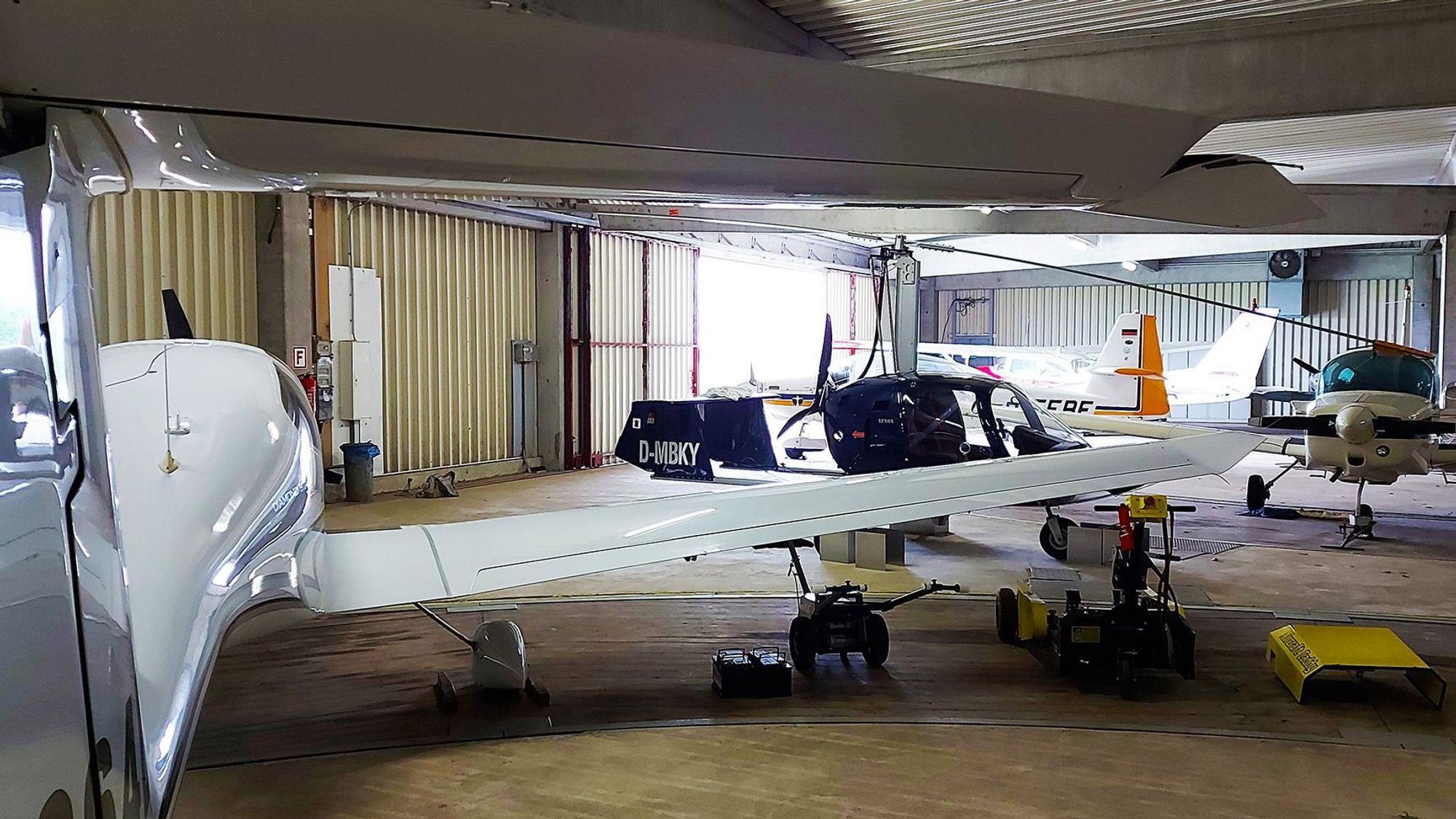 In einem Hangar stehen mehrere kleine Flugzeuge.