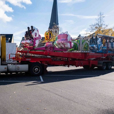 Ein Lastwagen mit einem Fahrgeschäft fährt auf den Kirmesplatz in Euskirchen.