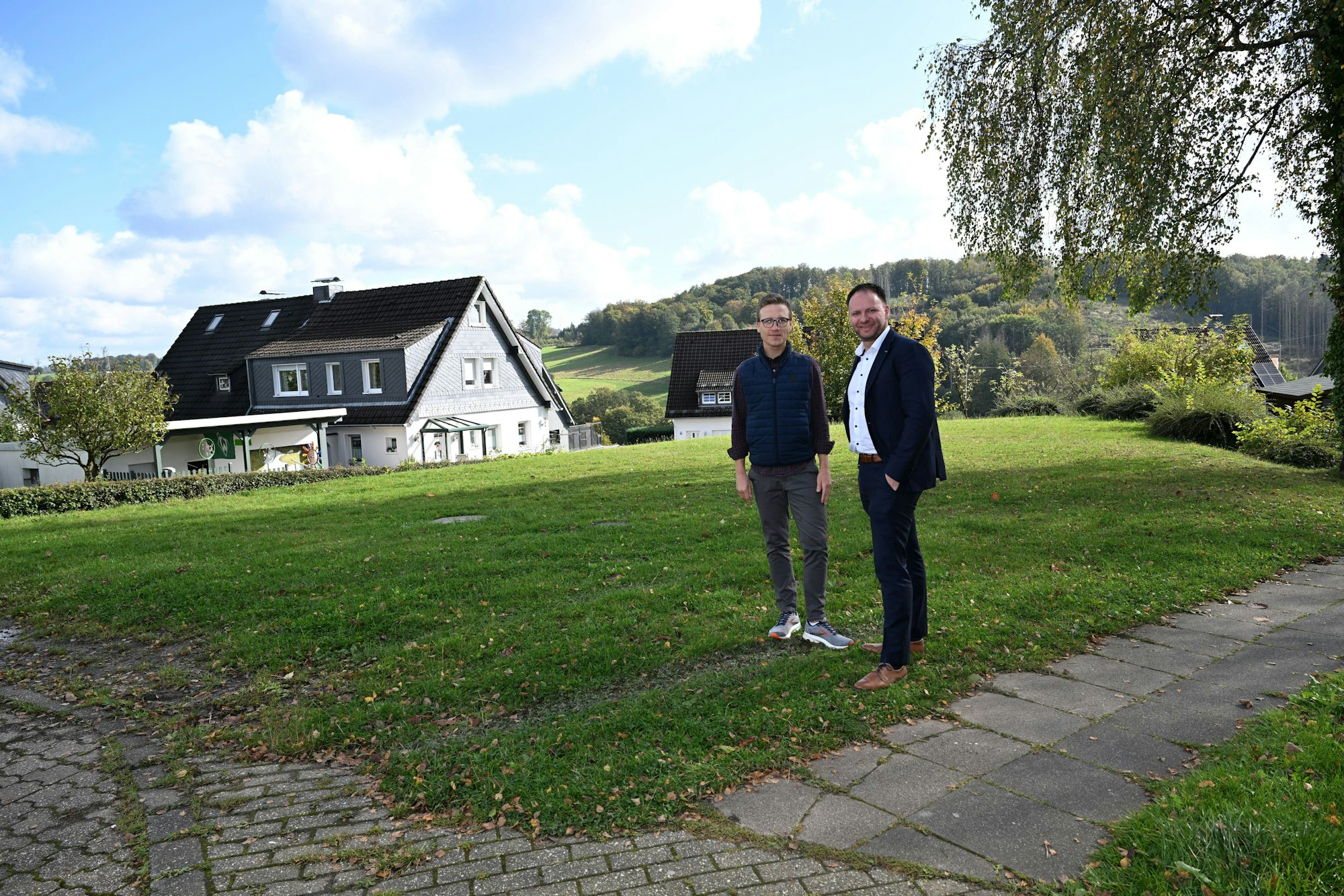 Torben Sauermann und Stefan Rappenhöner stehen auf einer Wiese, die künftig bei Festen genutzt werden kann.