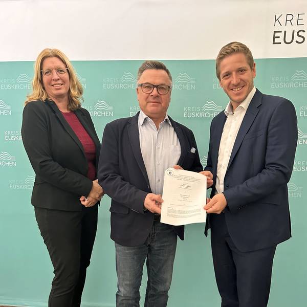 Das Bild zeigt die Julia Baron, Michael Krämer und Markus Ramers, wie sie den unterschriebenen Vertrag präsentieren.