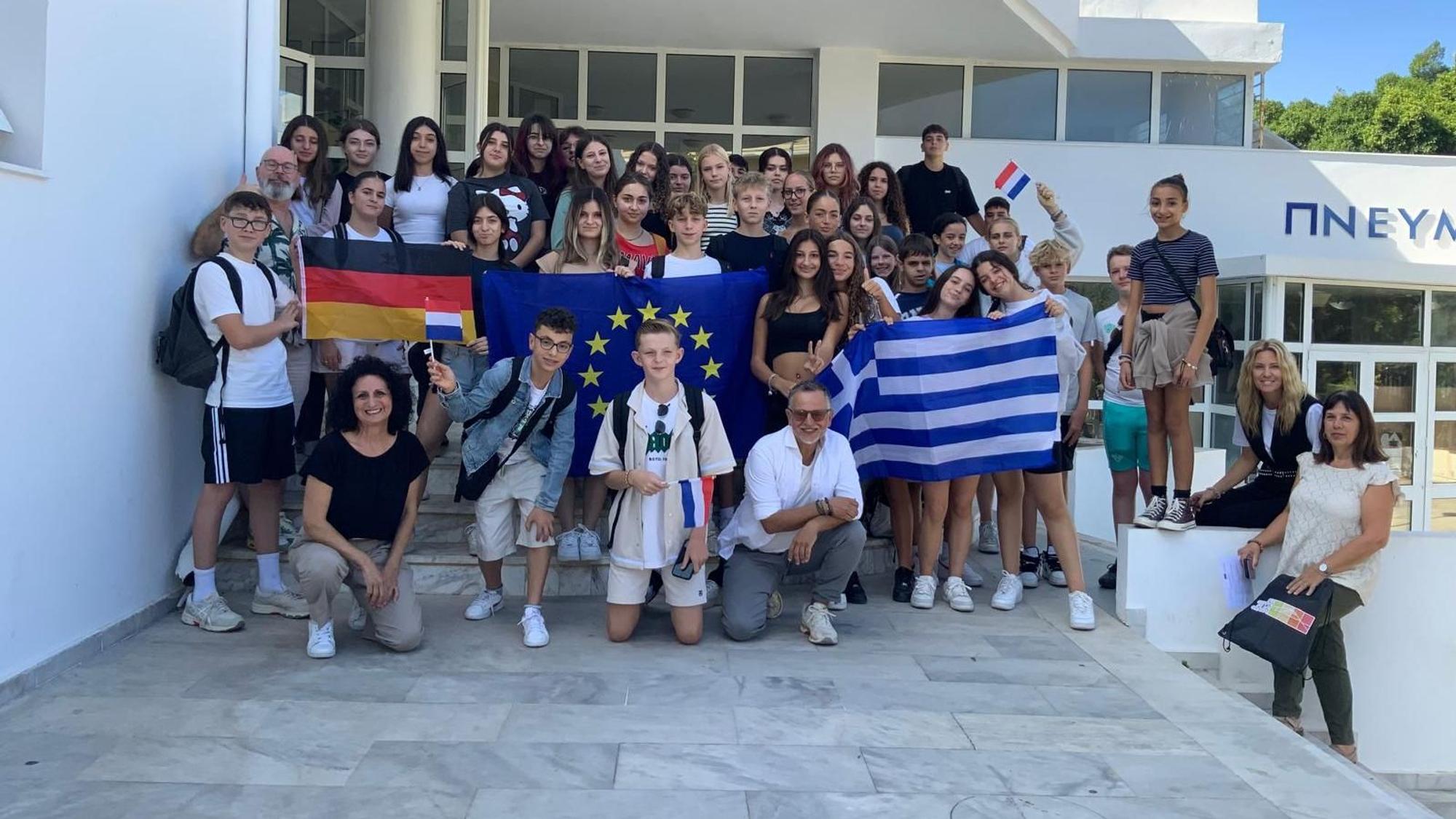 Das Bild zeigt Schülerinnen und Schüler, die diverse Flaggen hochhalten.