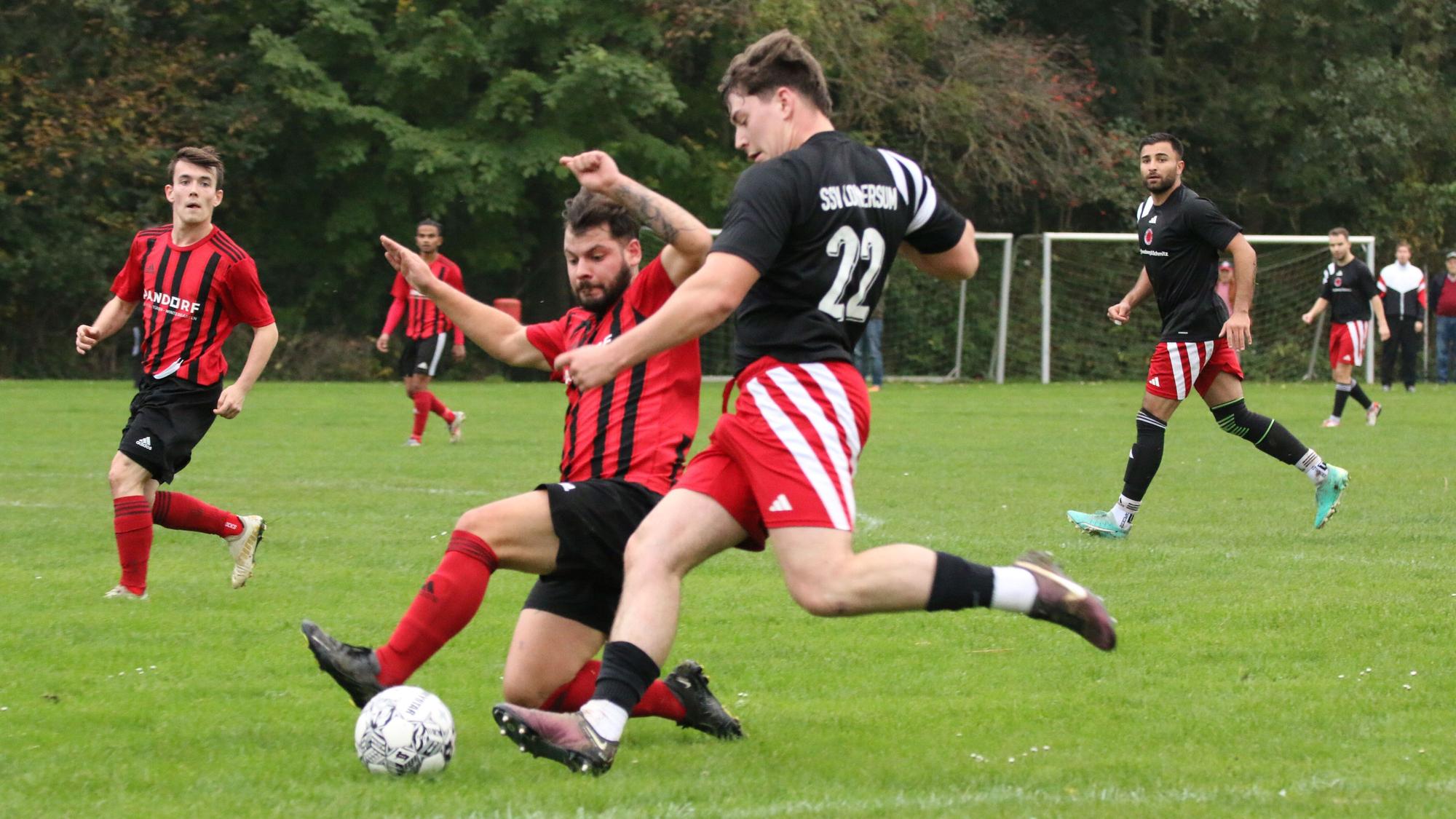 Das Bild zeigt einen Zweikampf zwischen zwei Fußballern.
