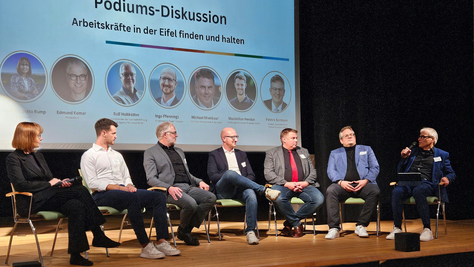 Die Teilnehmer einer Podiumsdiskussion der DLG Eifel sitzen auf der Bühne des Gemünder Kurhauses.