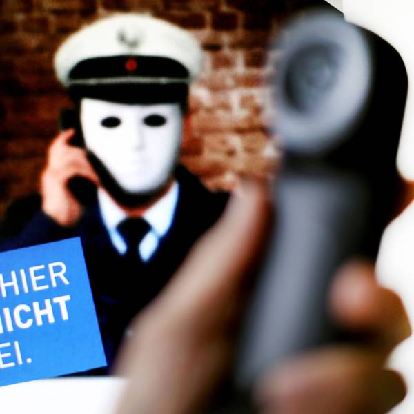 1.10.2017, Nordrhein-Westfalen, Düsseldorf: Ein Telefonhörer ist vor einem Plakat der Polizei NRW mit der Aufschrift «Achtung: Hier spricht nicht die Polizei» zu sehen.