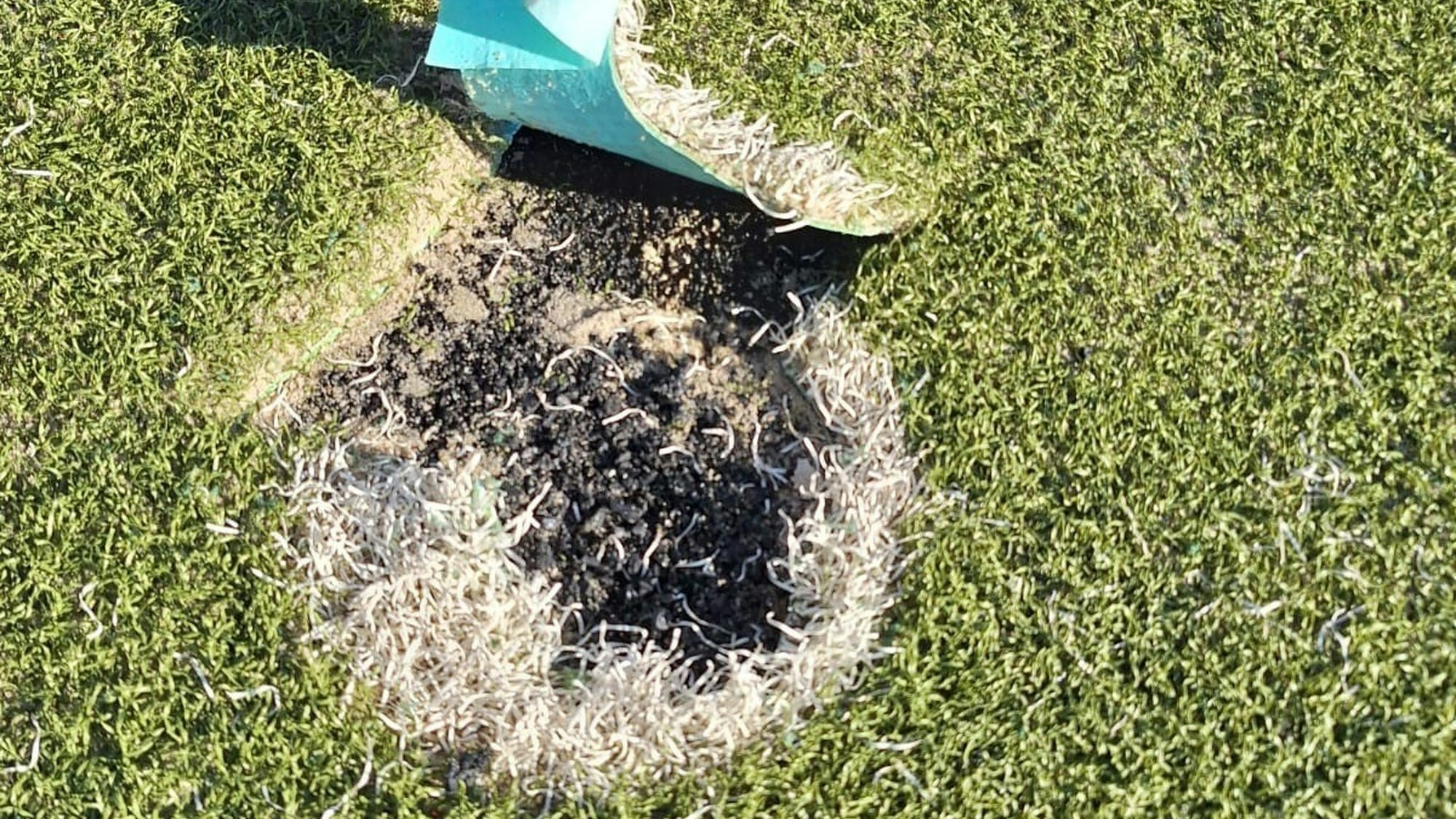 Das Bild zeigt den Kunstrasen. Dort, wo eigentlich ein weiß-gefärbter Elfmeterpunkt wäre, ist nun die Tragschicht zu sehen.