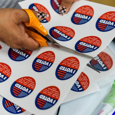 Ein Freiwilliger hilft beim Ausschneiden von „I Voted“-Aufklebern im Boyle Heights Senior Center.
