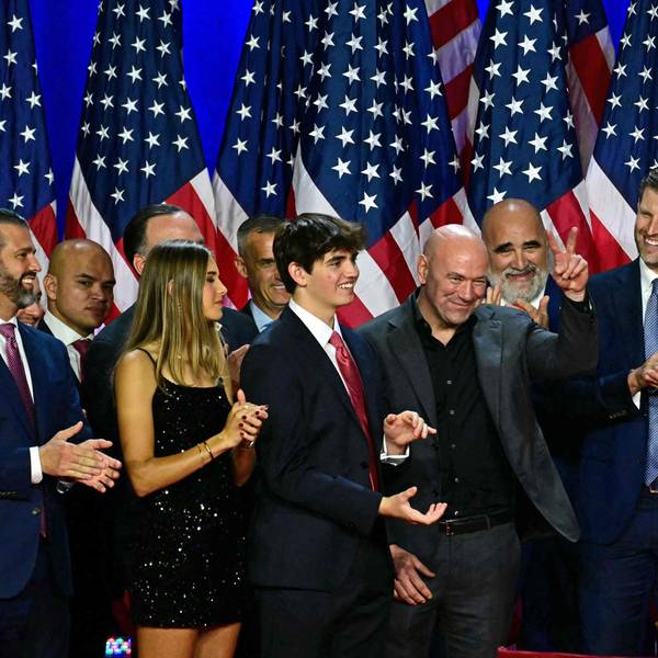 CEO of Ultimate Fighting Championship Dana White (C) gestures former US President and Republican presidential candidate Donald Trump acknowledges him during an election night event at the West Palm Beach Convention Center in West Palm Beach, Florida, on November 6, 2024. Republican former president Donald Trump closed in on a new term in the White House early November 6, 2024, just needing a handful of electoral votes to defeat Democratic Vice President Kamala Harris. (Photo by Jim WATSON / AFP)