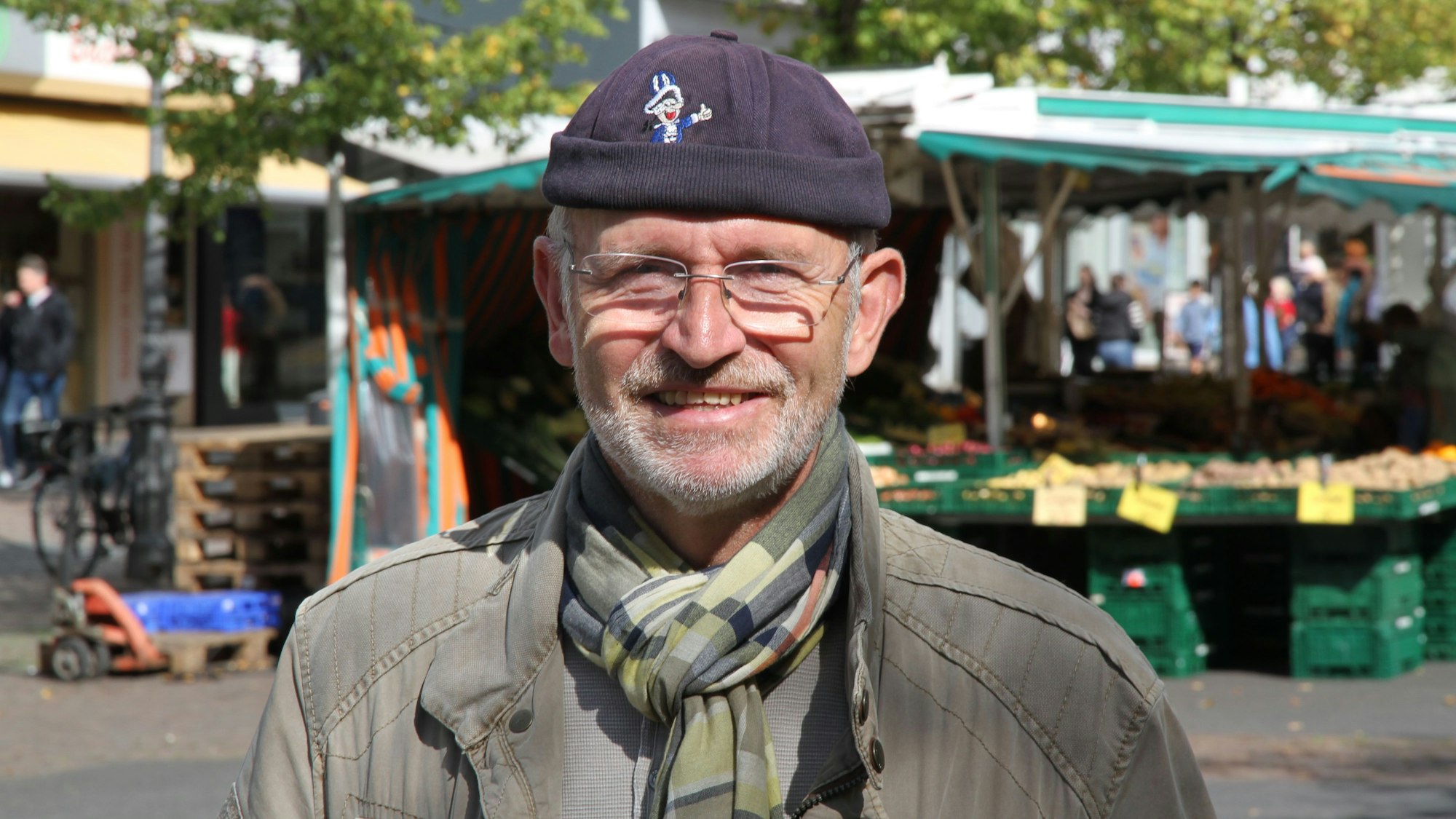 Ein Mann mit Mütze auf einem Marktplatz
