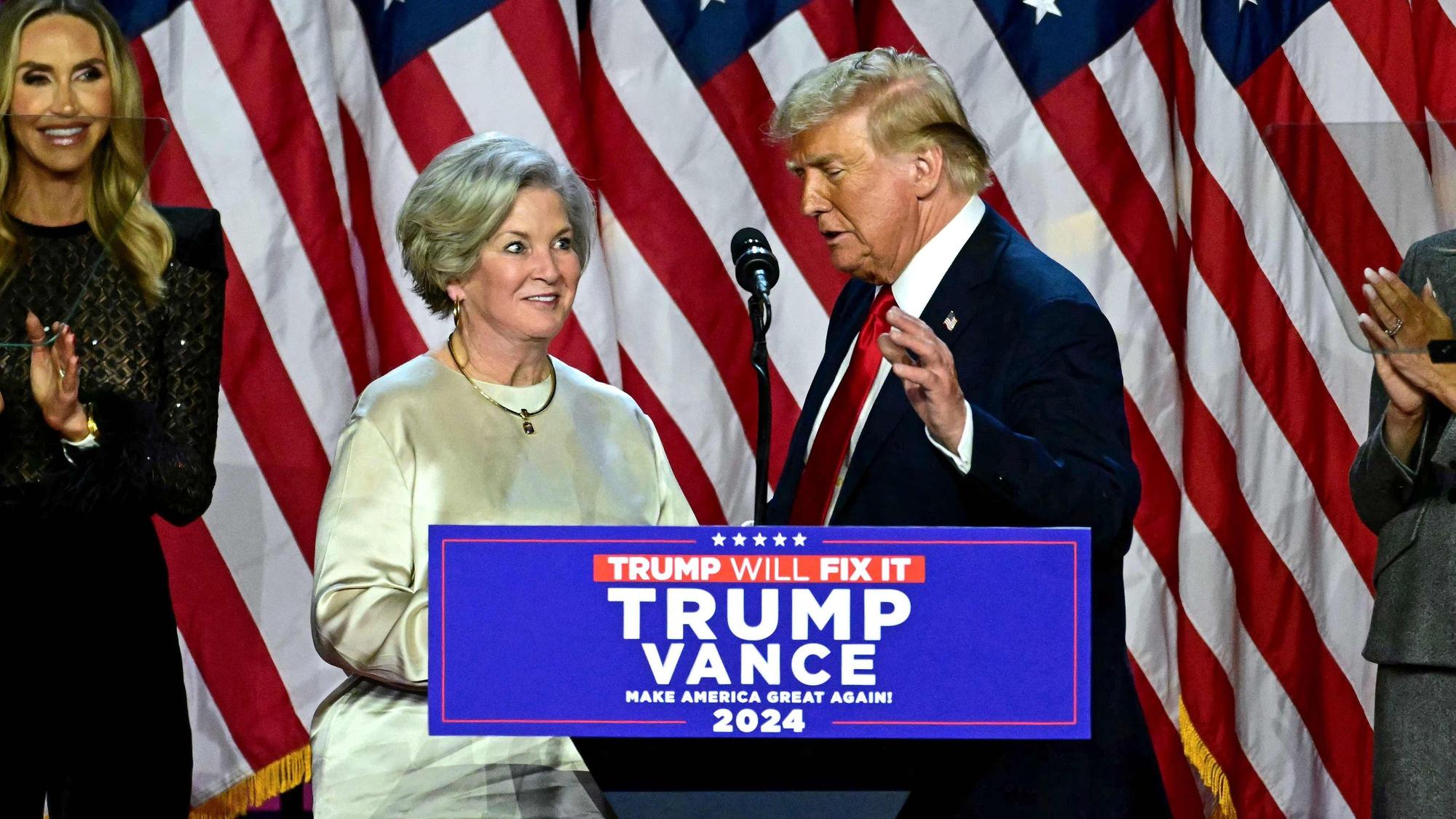 Former US President and Republican presidential candidate Donald Trump greets his campaign manager Susie Wiles (L) during an election night event at the West Palm Beach Convention Center in West Palm Beach, Florida, on November 6, 2024. Republican former president Donald Trump closed in on a new term in the White House early November 6, 2024, just needing a handful of electoral votes to defeat Democratic Vice President Kamala Harris. (Photo by Jim WATSON / AFP)