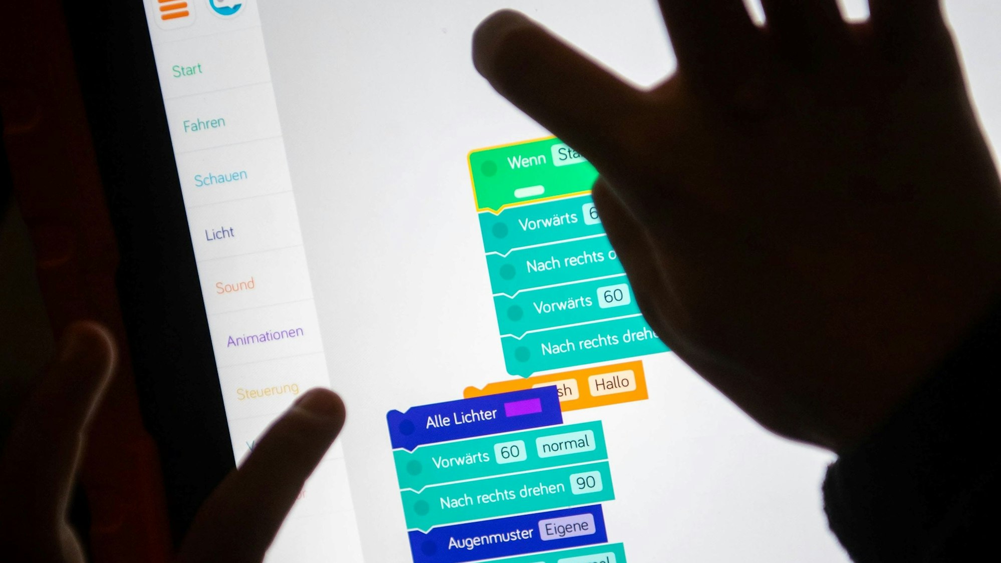 Kinderhände tippen auf den Bildschirm eines digitalen Endgeräts.