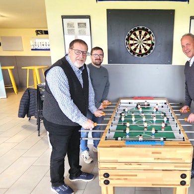 Michael Kehren, Bert Spilles, Brian Linden und Hermann-Josef Esser stehen an einem Fußballkicker.