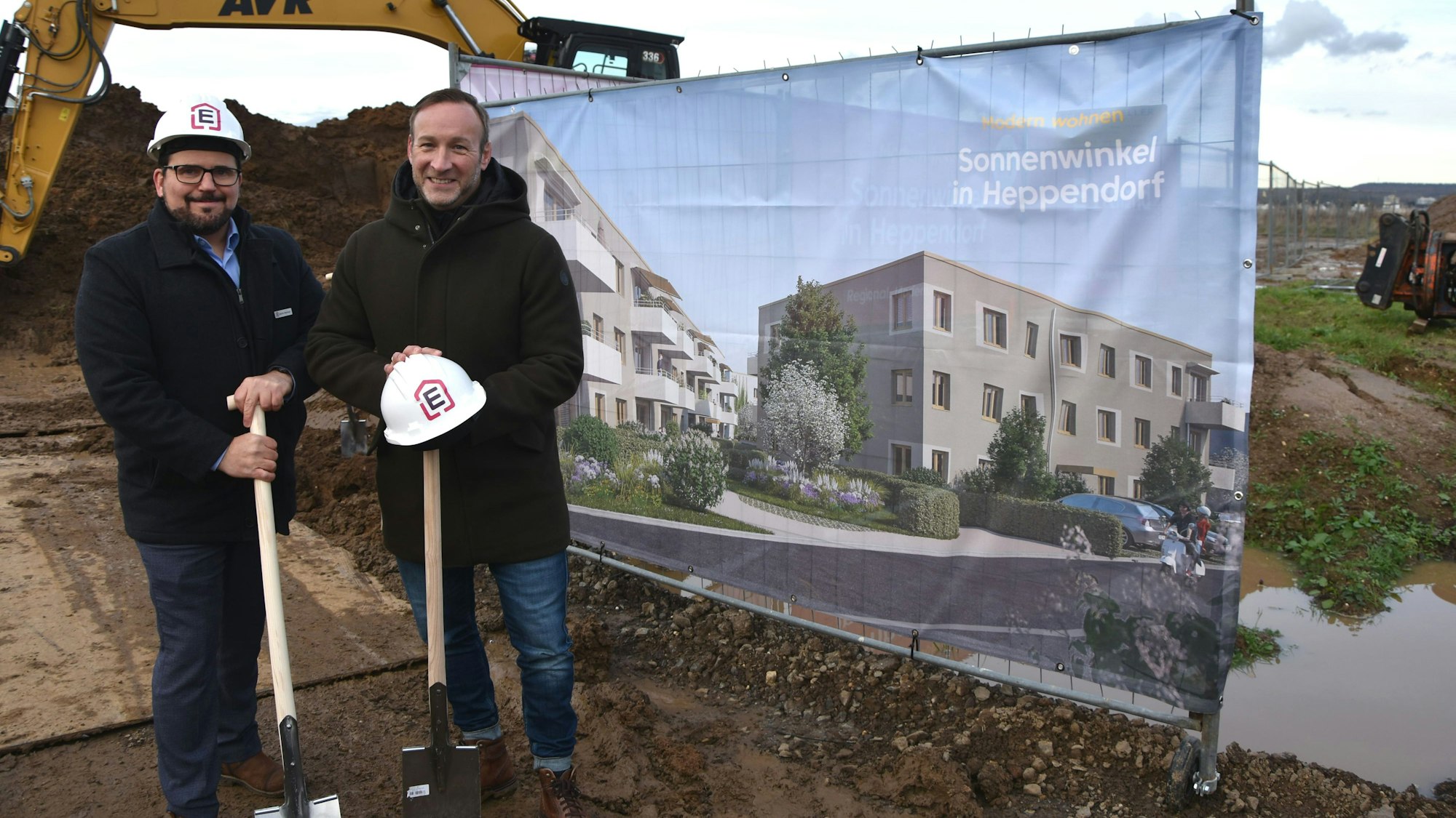 Zu sehen sind zwei Männer mit Spaten auf einer Baustelle.