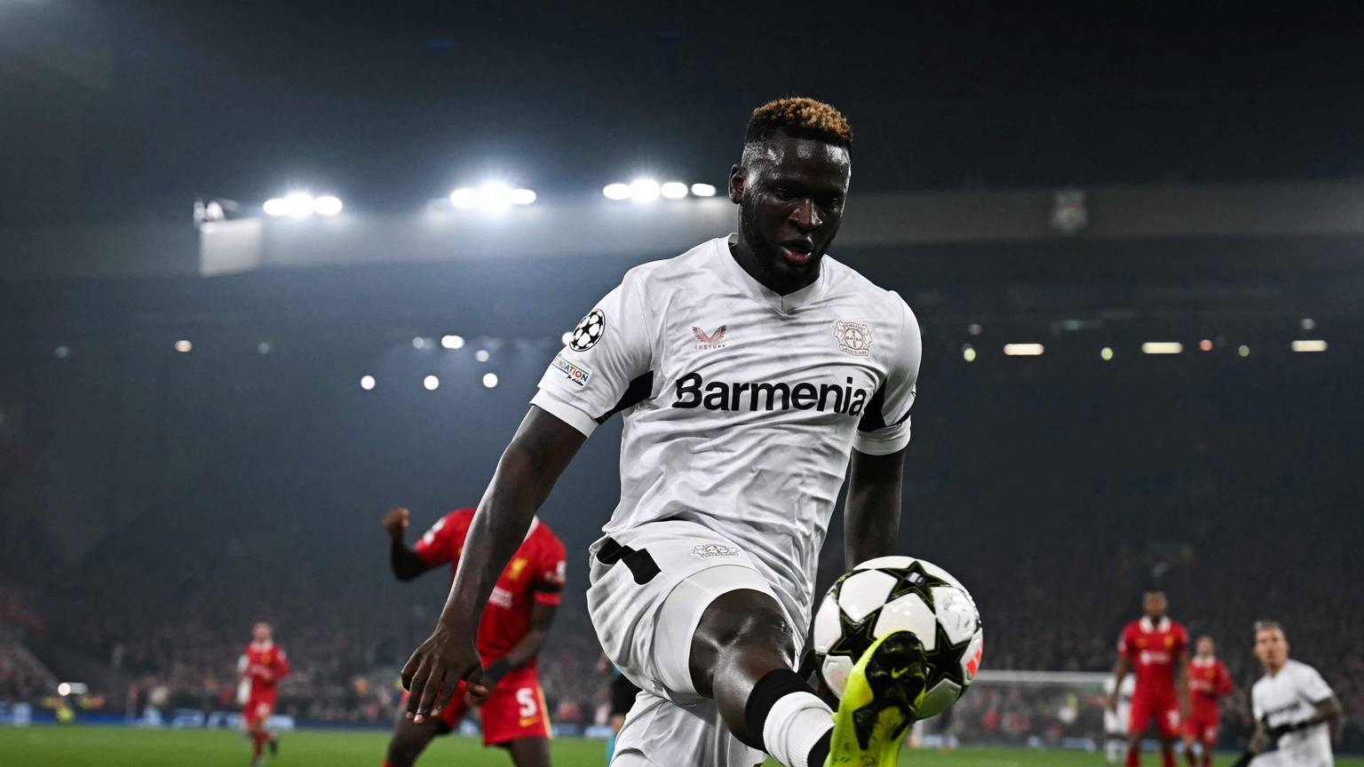 TOPSHOT - Bayer Leverkusen's Nigerian forward #22 Victor Boniface controls the ball during the UEFA Champions League football match between Liverpool and Bayer Leverkusen at Anfield stadium, in Liverpool, north west England, on November 5, 2024. (Photo by Paul ELLIS / AFP)