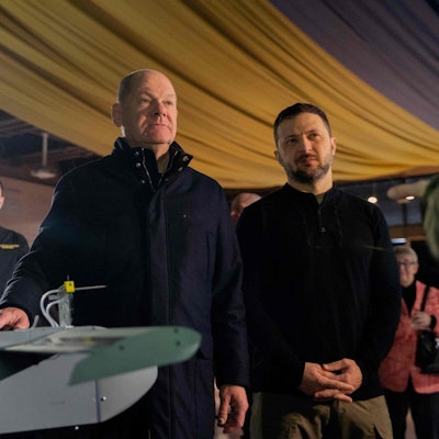 Ukrainian President Volodymyr Zelensky (R) and German Chancellor Olaf Scholz (C) get acquainted with the latest drones during Scholz's visit to Kyiv, on December 2, 2024, amid the Russian invasion of Ukraine. Scholz made a surprise visit to war-torn Ukraine on Monday to reaffirm Berlin's support for Kyiv in its fight against Russia. (Photo by Tetiana DZHAFAROVA / AFP)