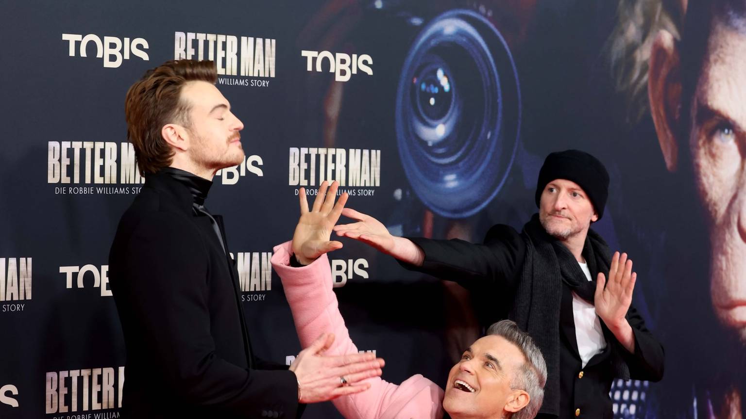 Robbie Williams bei der Filmpremiere ‚Better Man‘ mit Darsteller Jonno Davies (links) und Regisseur Michael Gracey.