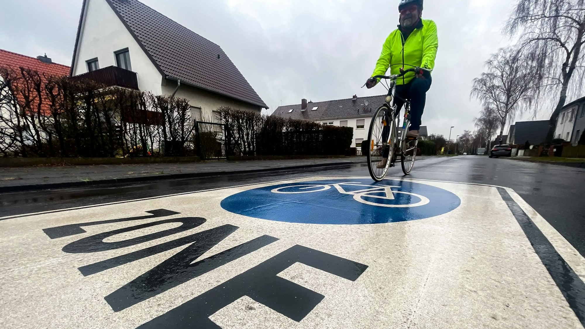 Das Bild zeigt einen Radfahrer, der im Auel unterwegs ist und über das Radfahr-Piktogramm fährt.