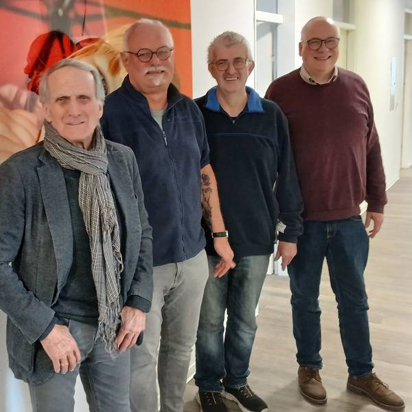 Vier Männer in einem Flur