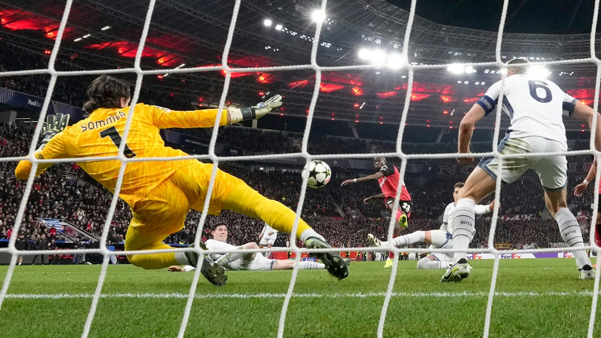 Leverkusen's Nordi Mukiele scores the decisive goal against Inter Milan's goalkeeper Yann Sommer during the Champions League opening phase soccer match between Bayer Leverkusen and Inter Milan at the BayArena in Leverkusen, Germany, Tuesday Dec. 10, 2024. (AP Photo/Martin Meissner)