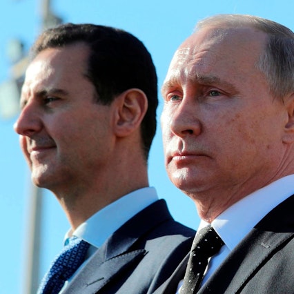 FILE - Russian President Vladimir Putin, right, and Syrian President Bashar Assad watch troops marching at the Hemeimeem air base in Syria, on Dec. 11, 2017. (Mikhail Klimentyev, Sputnik, Kremlin Pool Photo via AP, File)
