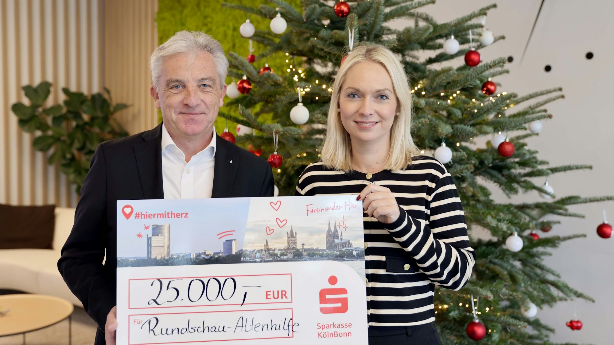 „Es kommt von Herzen“: Rainer Virnich vom Vorstand der Sparkasse Köln Bonn überreicht Julia Heinen den Scheck für die Altenhilfe.