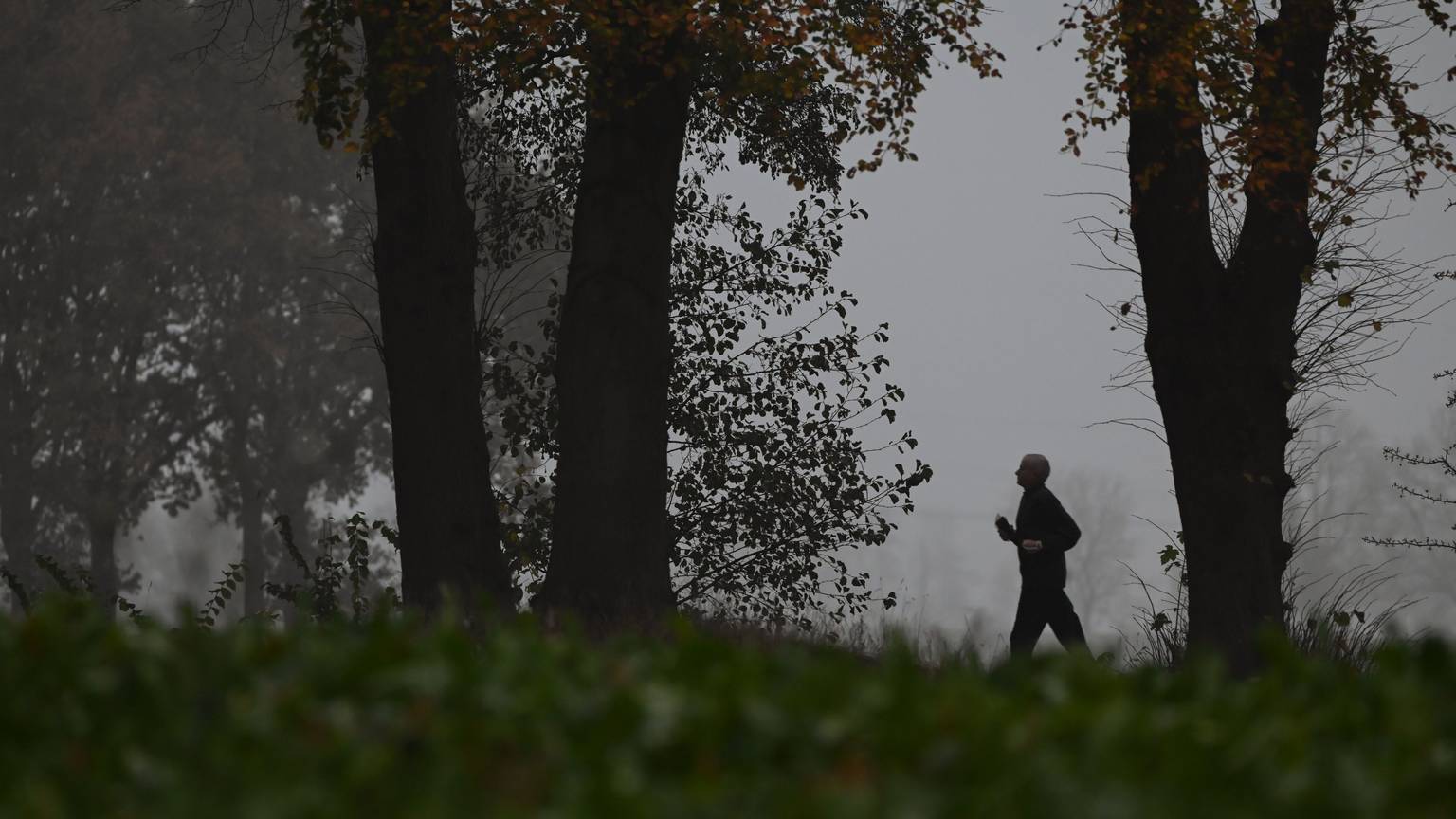 Ein Jogger joggt bei diesigem Wetter