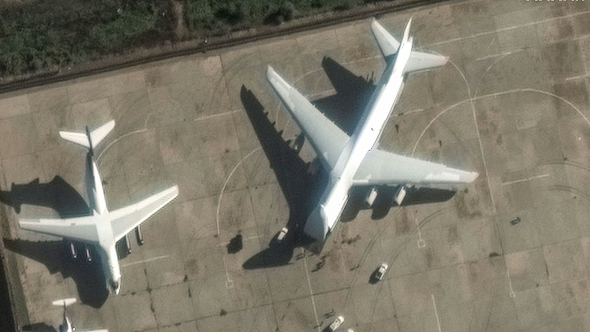 This handout satellite image released by Maxar Technologies on December 13, 2024 shows an Antonov An-124 heavy transport aircraft preparing to load equipment at the Russian Hmeimim Air Base in Syria's western province of Latakia. Islamist-led rebels took the Syrian capital Damascus in a lightning offensive on December 8, ousting president Bashar al-Assad and ending five decades of Baath rule in the country. Assad was propped up by Russia, where he reportedly fled, as well as Iran and Lebanon's Hezbollah militant group. (Photo by Satellite image ©2024 Maxar Technologies / AFP) / RESTRICTED TO EDITORIAL USE - MANDATORY CREDIT "AFP PHOTO / SATELLITE IMAGE ©2024 MAXAR TECHNOLOGIES" - NO MARKETING NO ADVERTISING CAMPAIGNS - DISTRIBUTED AS A SERVICE TO CLIENTS